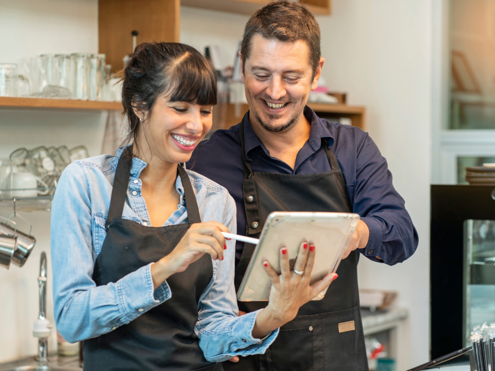 happy juice bar owners reading their acai profit on the tablet